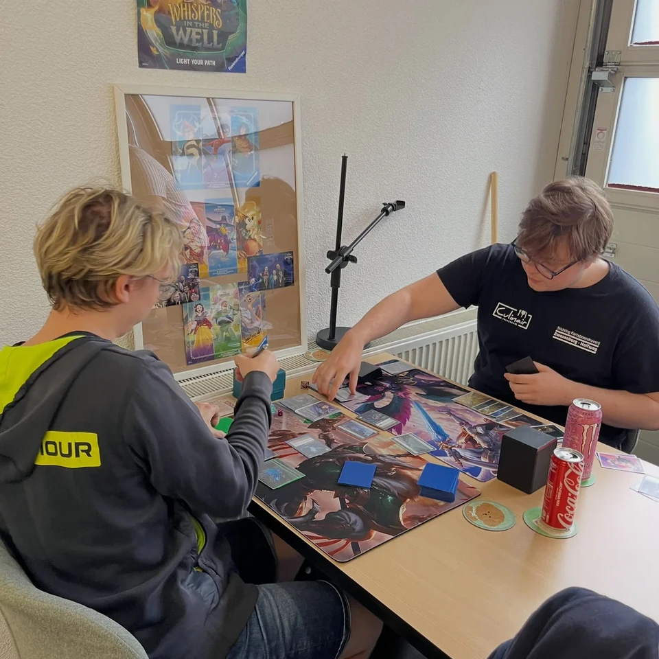 Two players playing Disney Lorcana at a table in ShibeTCG